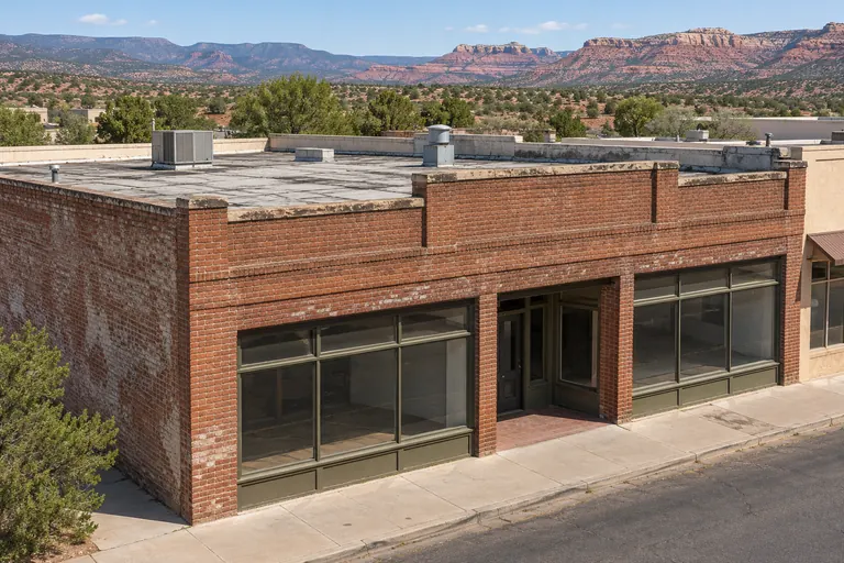 Older two-story brick commercial building with a flat roof behind its parapet
